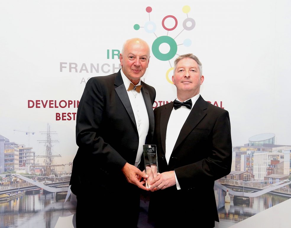 NewsTalk's Bobby Kerr awarding Dermot Keenan of AIL Group the 'Best Franchise System & Business Practice 2018' award.